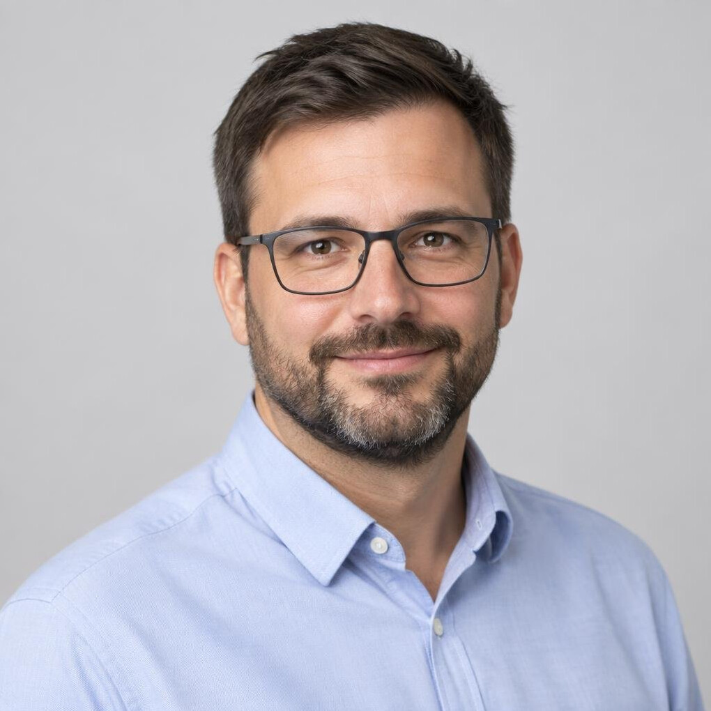 Studio portrait of a Croatian man with short beard wearing glasses