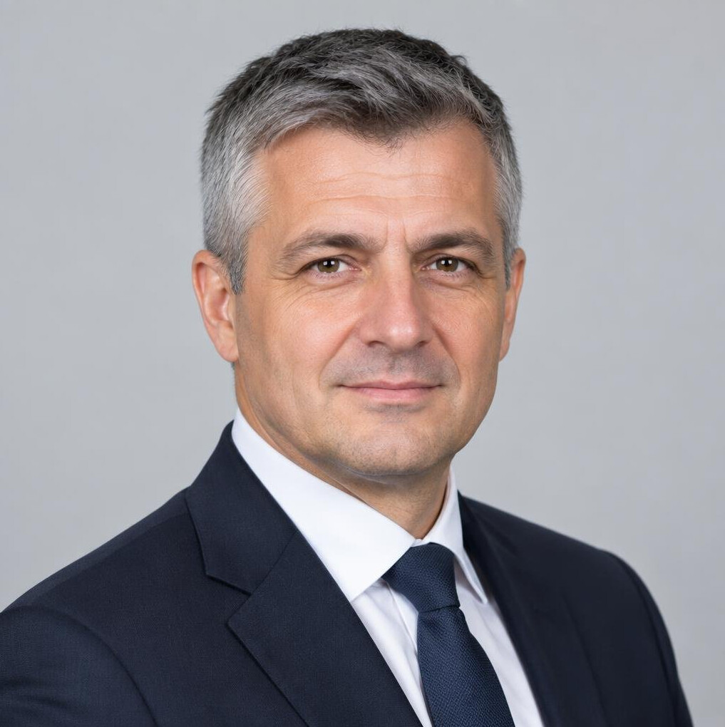 Studio portrait of a Croatian man with short hair wearing a suit jacket